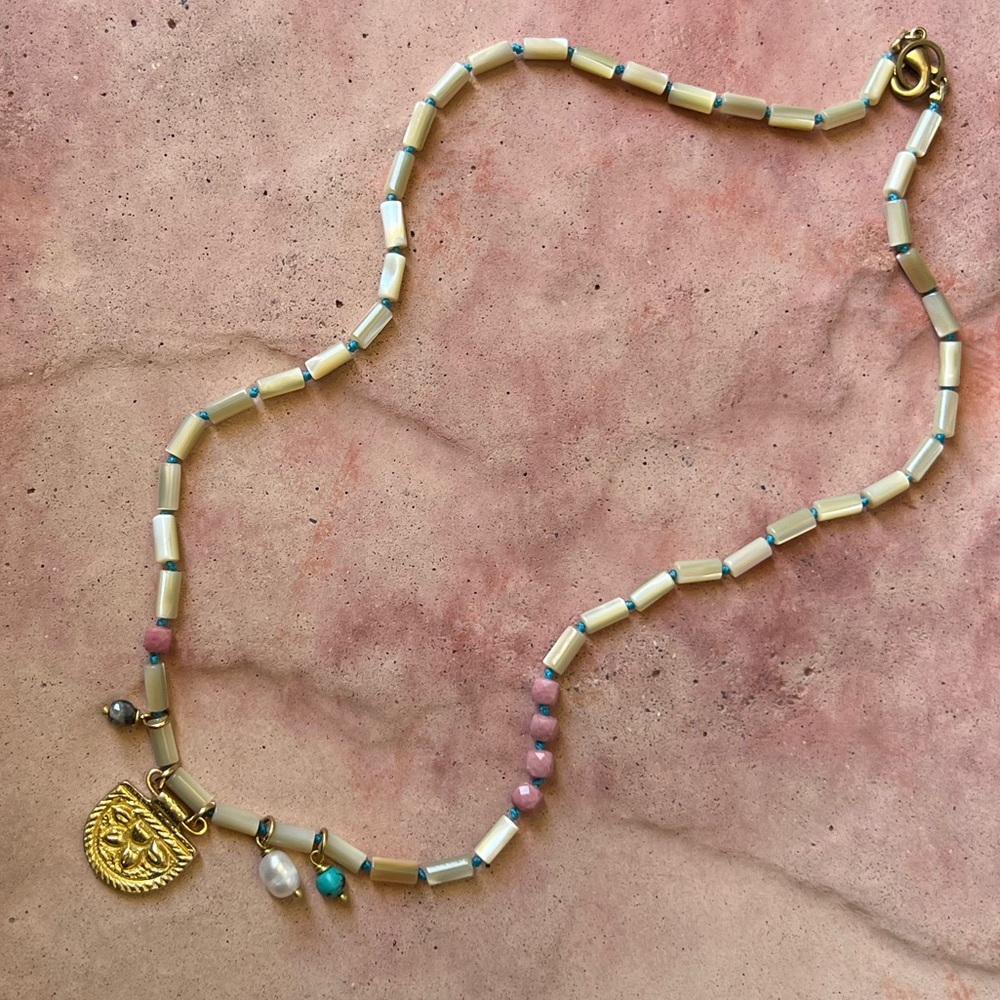 Handmade hand knotted mother of pearl asymmetrical necklace.